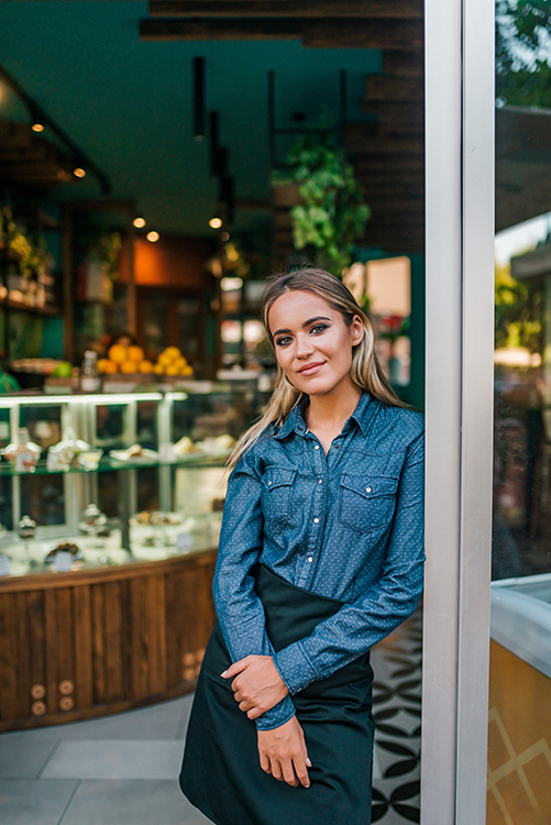 Portrait of a beautiful waitress at small business shop.